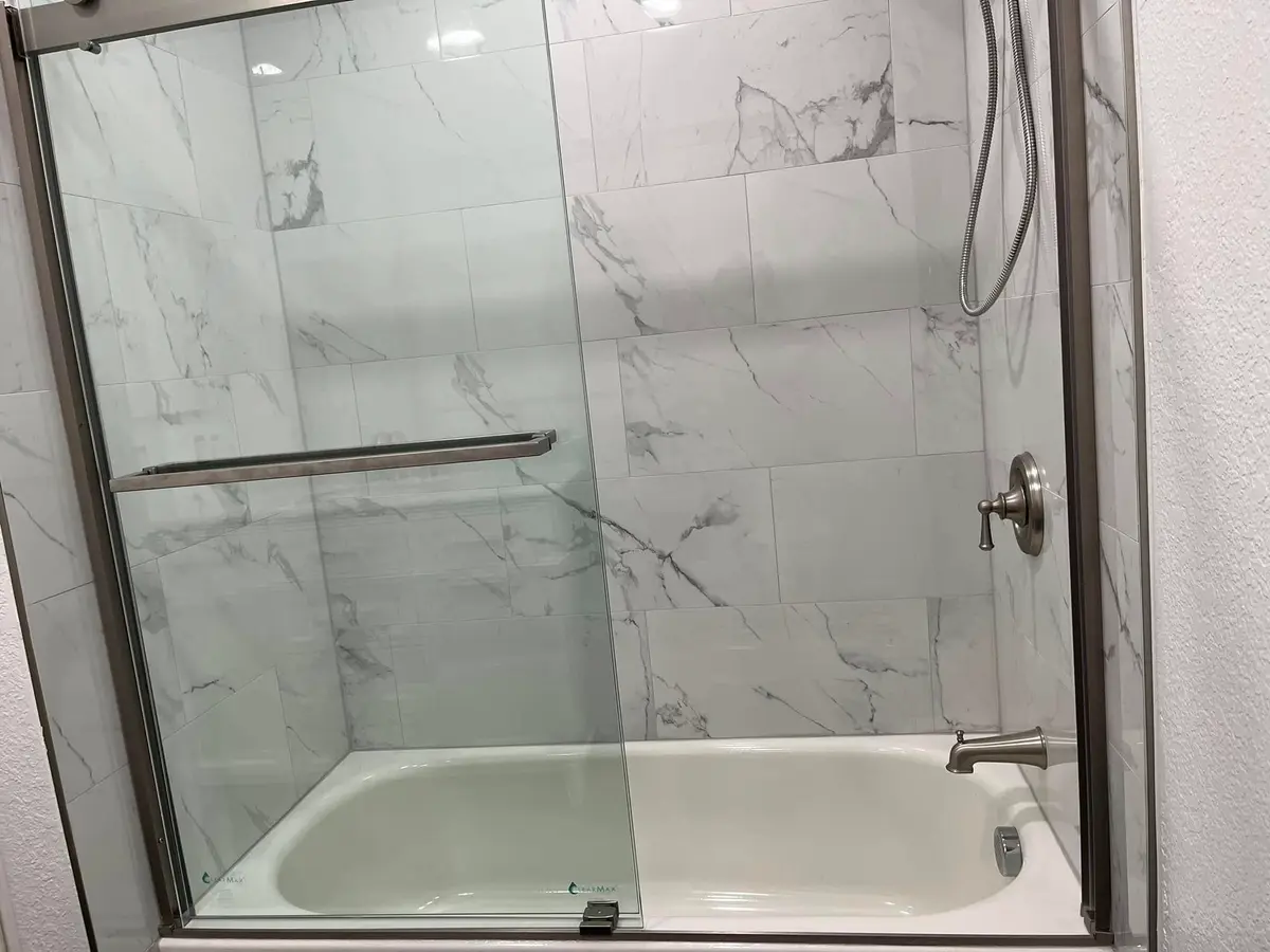 Bathroom remodeling in Vallejo with marble-look shower walls and sliding glass door