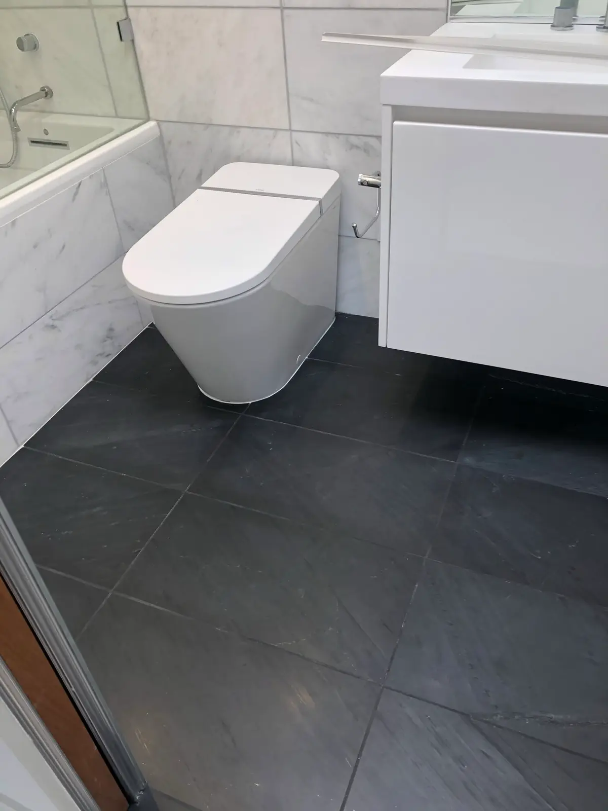 Flooring installation in Vallejo: dark slate-look tile floor in a bathroom
