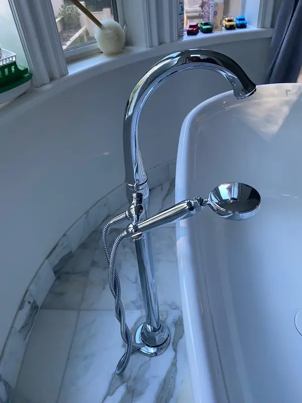 Plumber in Vallejo connecting a floor-mounted chrome tub faucet