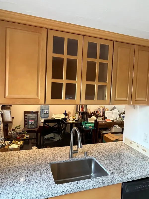 Kitchen cabinets in Vallejo: maple cabinets with glass-front doors above granite counter