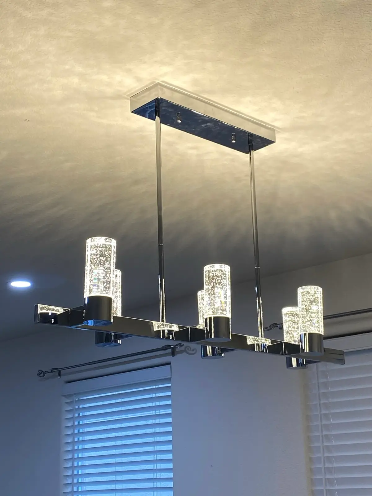 Electrician in Vallejo hanging a modern crystal linear chandelier