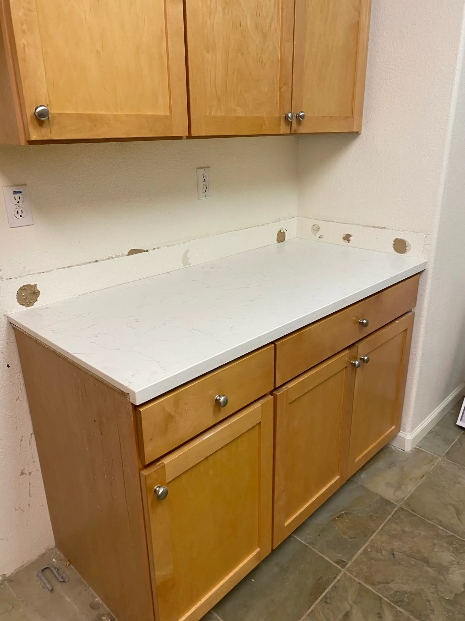 White quartz countertop installed over honey cabinets in Vallejo