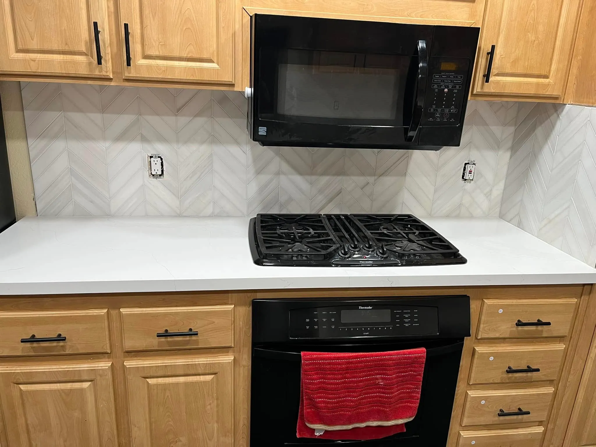 Chevron tile backsplash above a gas cooktop in a kitchen remodel in Vallejo