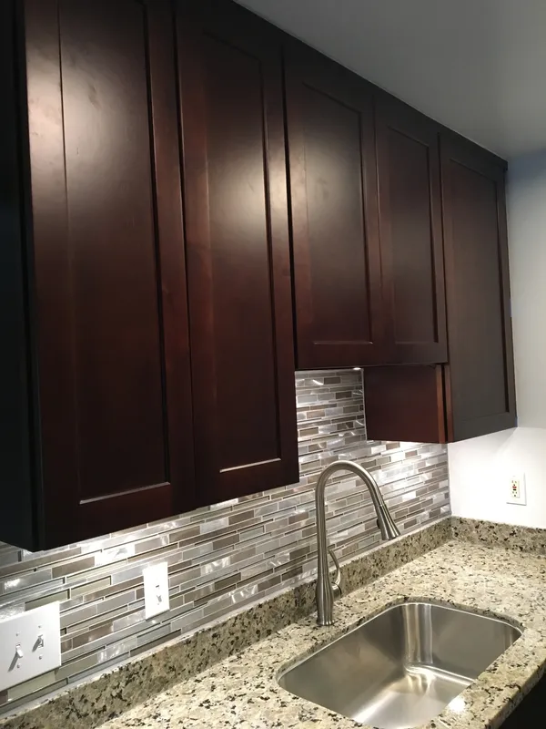 Dark espresso cabinets with a mosaic glass tile backsplash in a Vallejo kitchen
