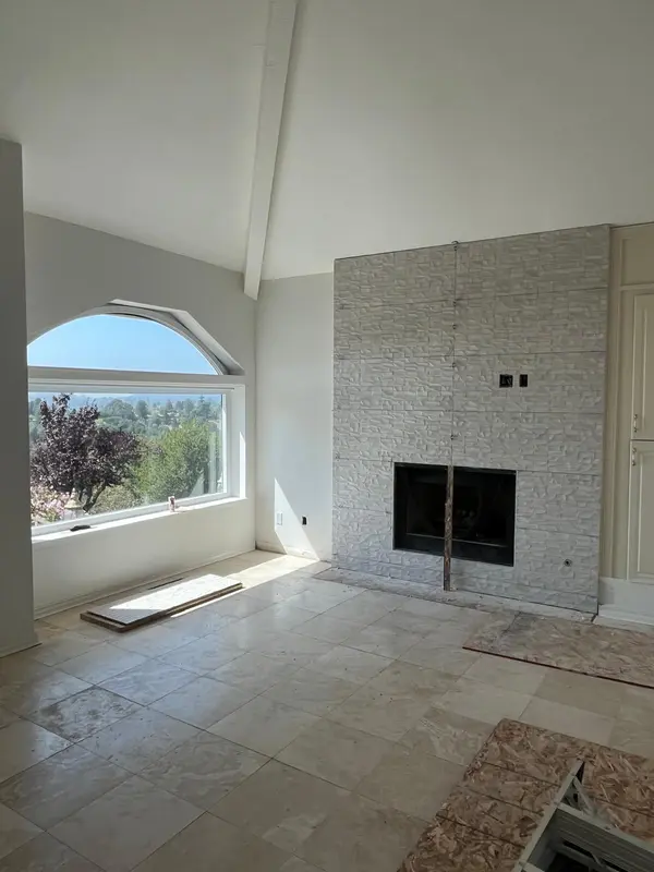 Home remodeling in Vallejo with a stacked-stone tile fireplace wall in progress
