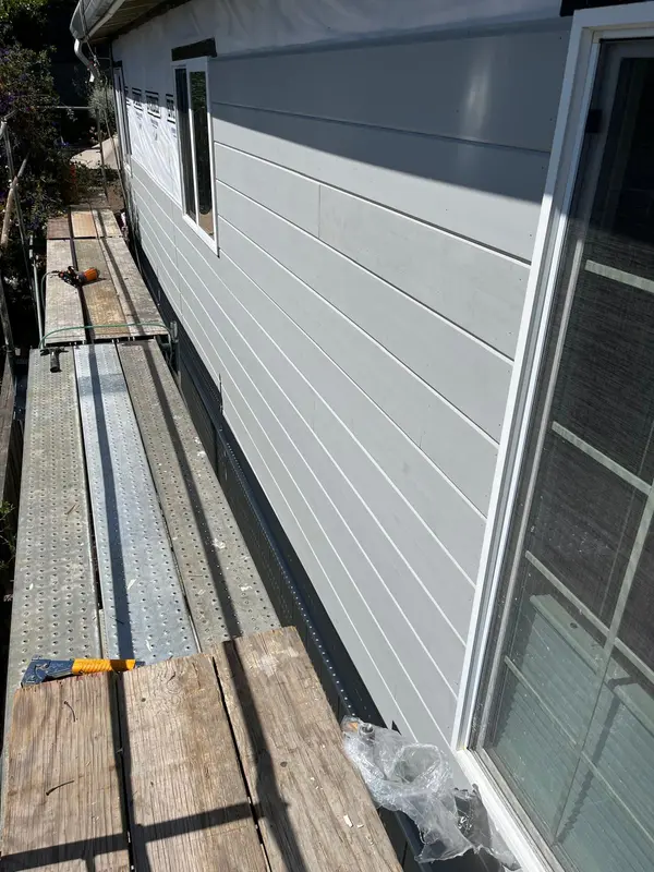 Siding contractor in Vallejo: long run of gray lap siding with work platform